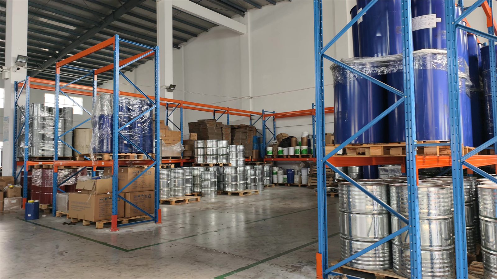 Warehouse racks with coating drums and containers