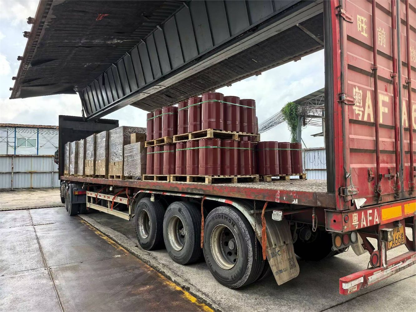 Coating drums and packaged goods being loaded for shipment