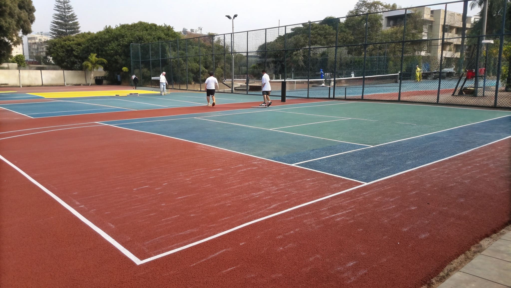 Different types of sports court surfaces side-by-side
